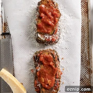 Eggplant piled into layers of eggplant, marinara, and parmesan.