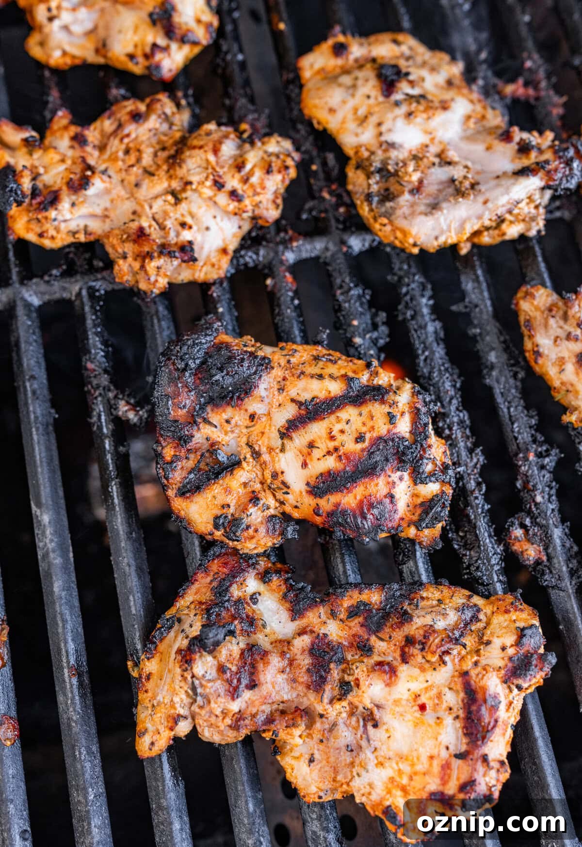 Greek Yogurt Chicken Marinade for Juicy Grilled Chicken 11 Chicken on a lit grill after cooking on one side and flipping.