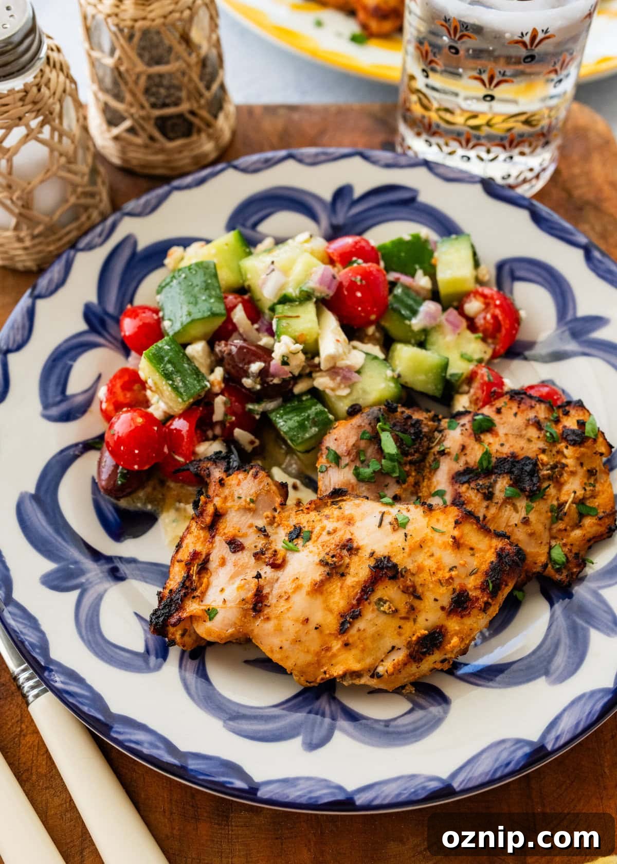 Greek Yogurt Chicken Marinade for Juicy Grilled Chicken 13 One piece of chicken on a dish plated with a side.