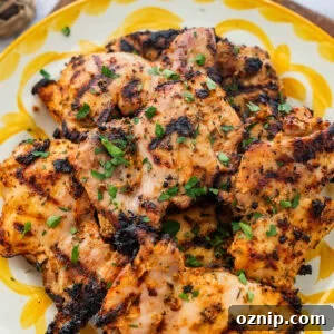 Greek Yogurt Chicken Marinade for Juicy Grilled Chicken 14 Chicken on a serving dish with garnish.