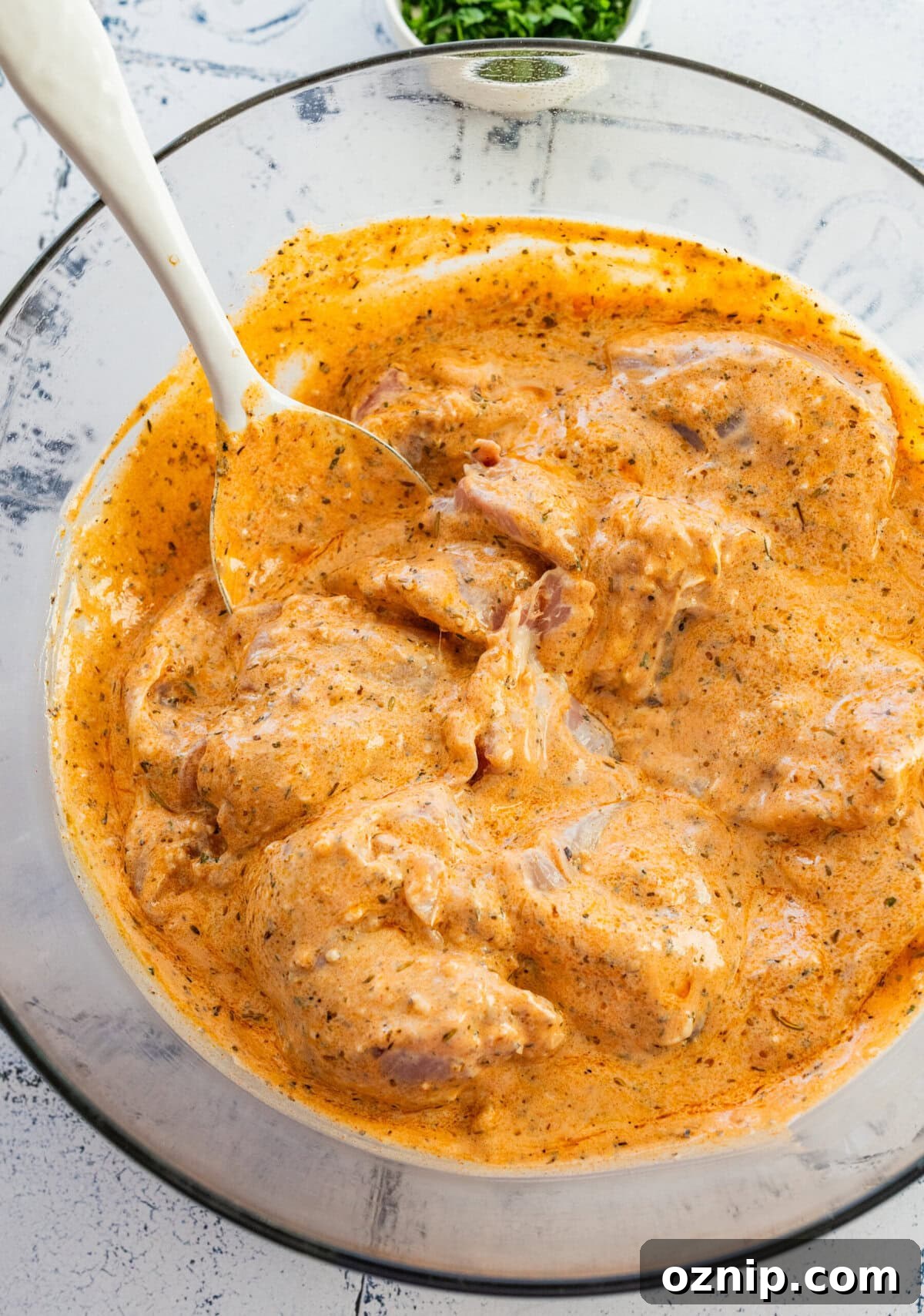 Greek Yogurt Chicken Marinade for Juicy Grilled Chicken 9 Chicken in a bowl of marinade after mixing.