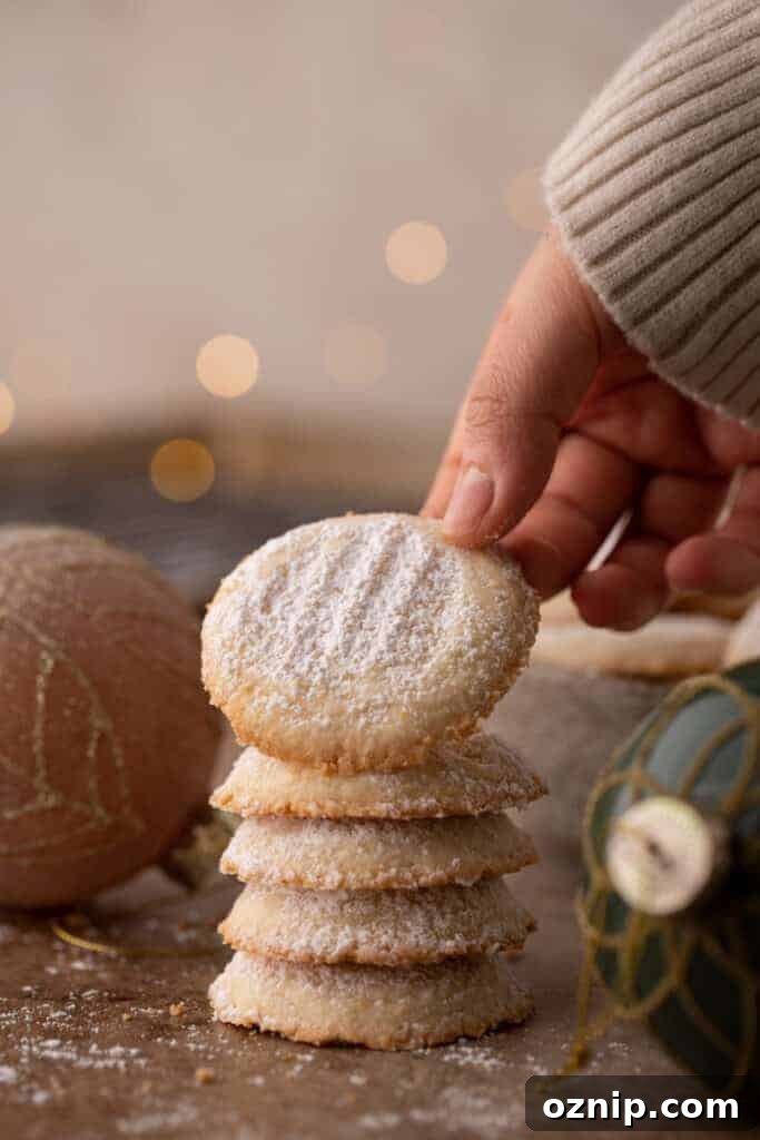 Melting Moments Cookies Recipe That Melt in Your Mouth 2 multiple melting moments cookies stacked on top of each other with the top one being held up by a hand