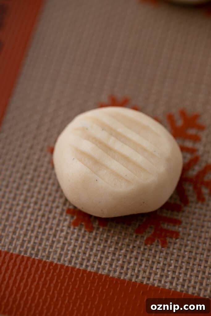 Melting Moments Cookies Recipe That Melt in Your Mouth 8 close up of raw cookie dough with a marking from a fork pressed on top