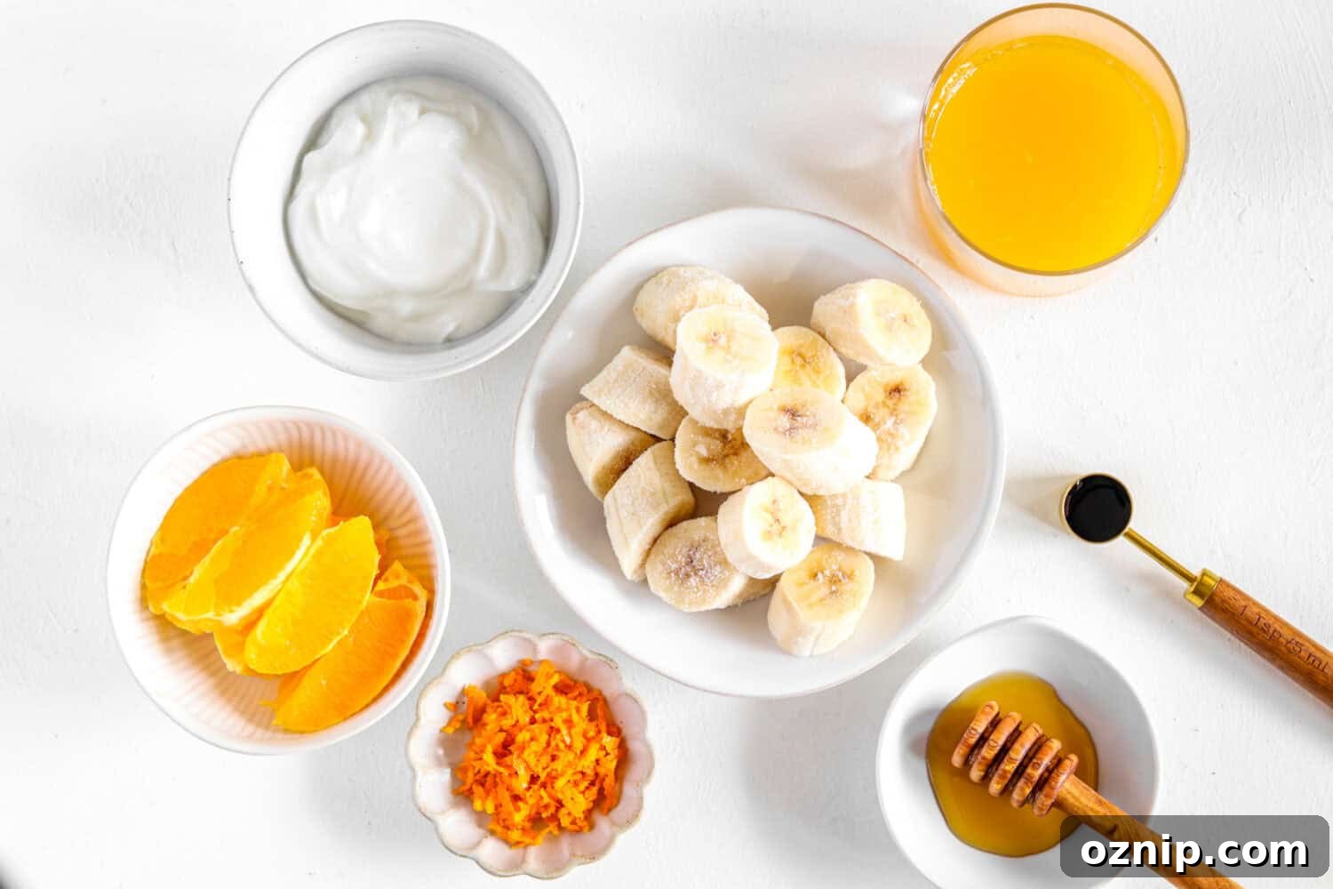 Chopped frozen bananas, orange slices, orange juice, orange zest, yogurt, yogurt and vanilla extract