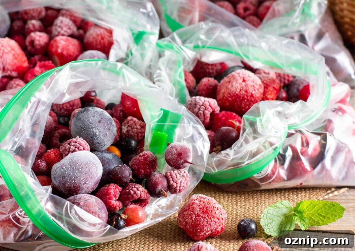 Frozen berries in plastic bags on a wooden table.