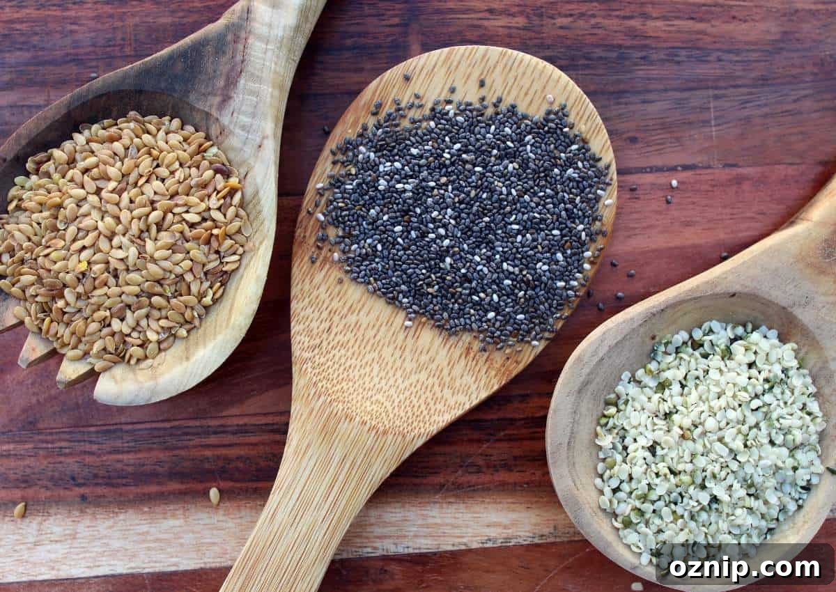 Chia seeds in wooden spoons on a wooden table.