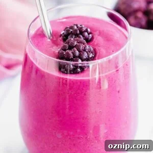 A smoothie with blackberries and bananas in a glass.