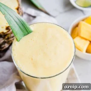 Close up of 3 ingredient mango pineapple smoothie in a glass.