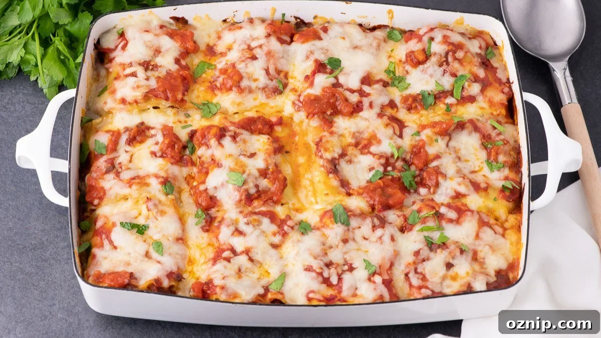 Lasagna roll ups in a white baking dish.