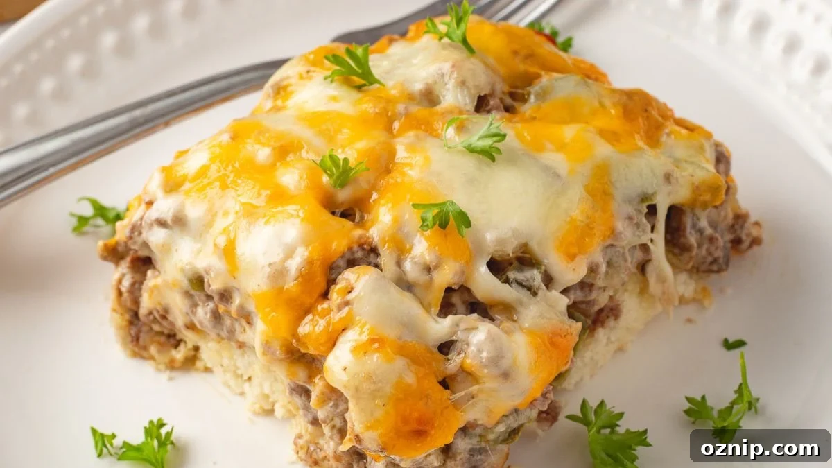 Philly cheesesteak casserole served on a white plate with a fork on the side.