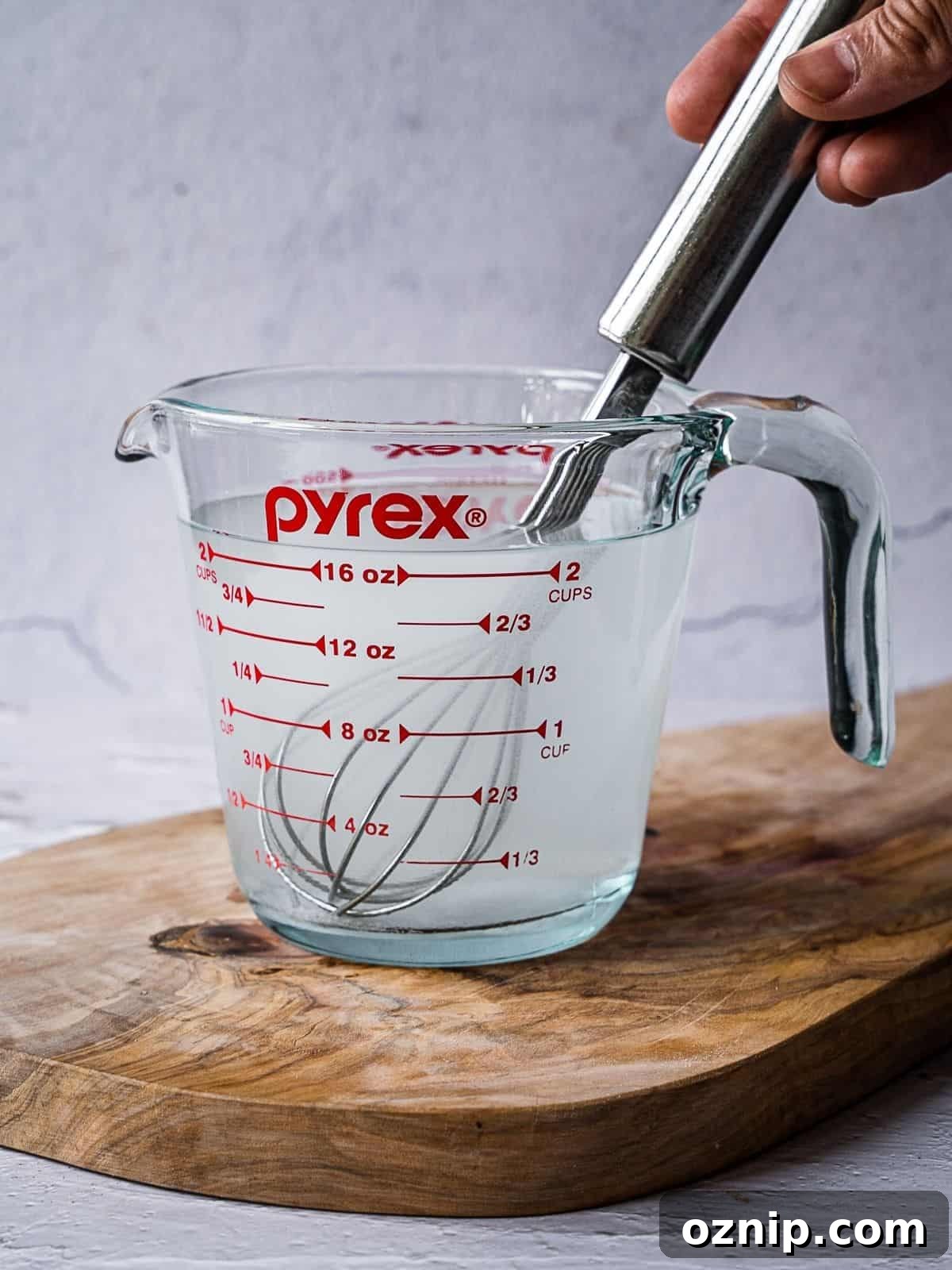 A pyrex measuring cup with saltwater brine.