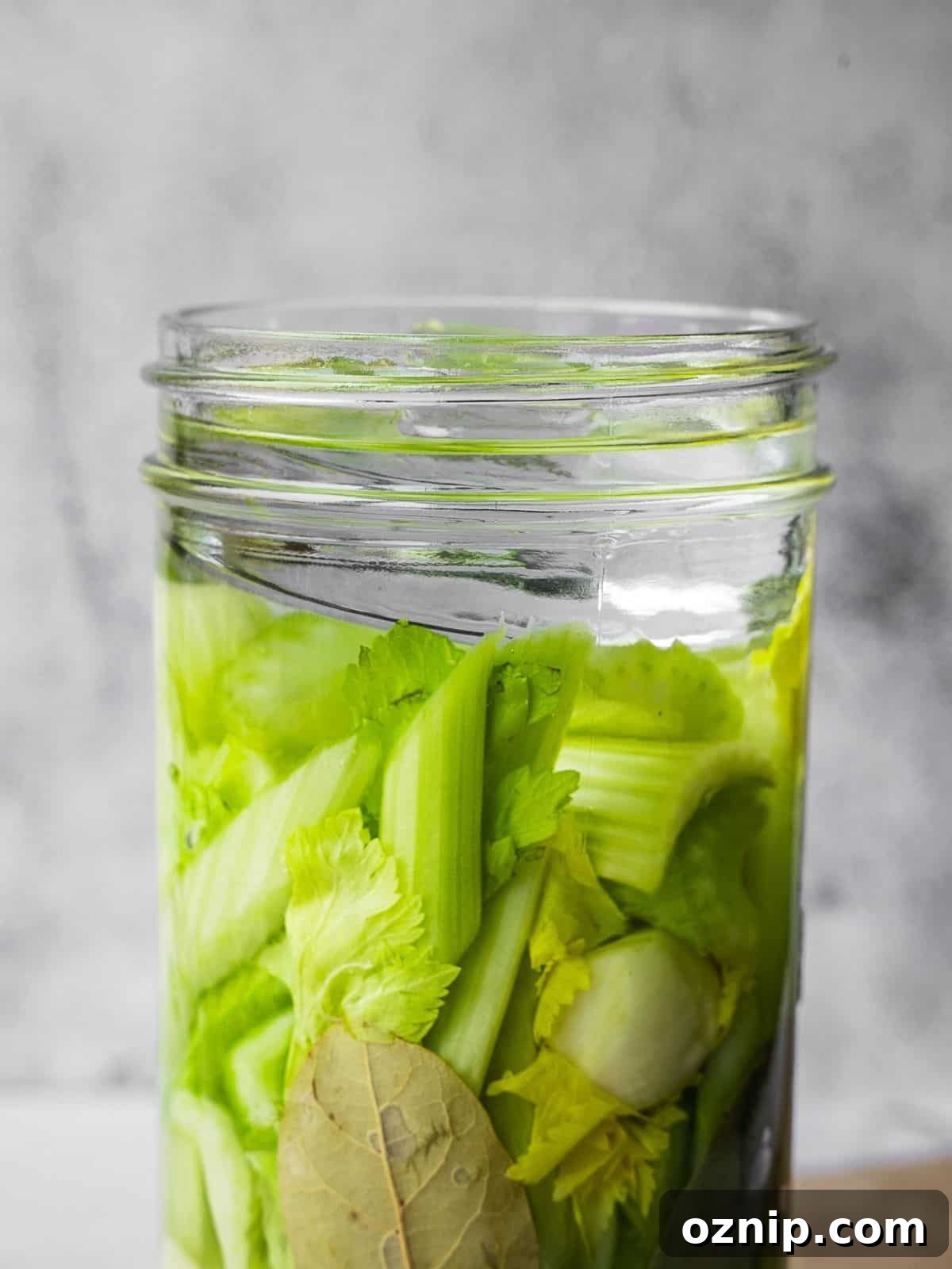 Brine covering the vegetables in a mason jar.