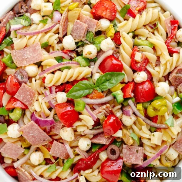 Antipasto pasta salad in a white serving bowl.