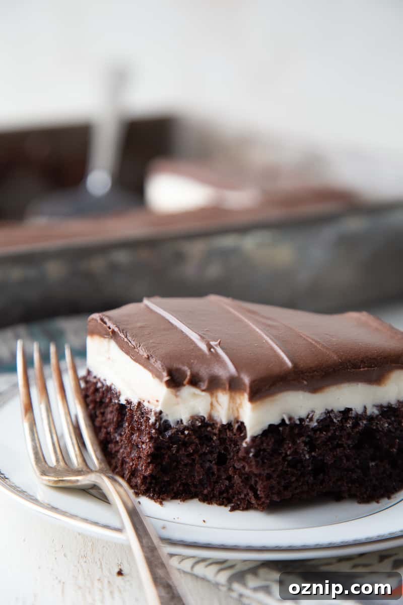 Ding Dong cake slice on a plate with a bite taken out and a fork next to it.